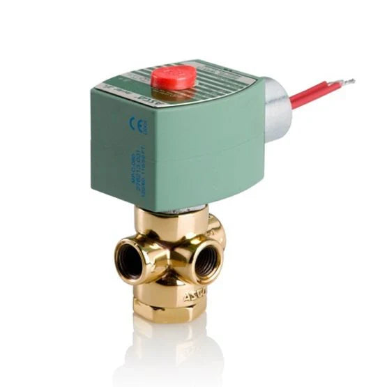Brass valve with green actuator and red button on a white background