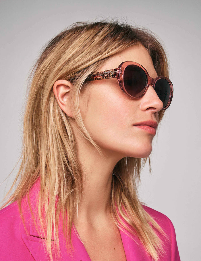 Anne Klein oversized oval sunglasses in pink crystal acetate with abstract plaid temples and brown gradient lenses