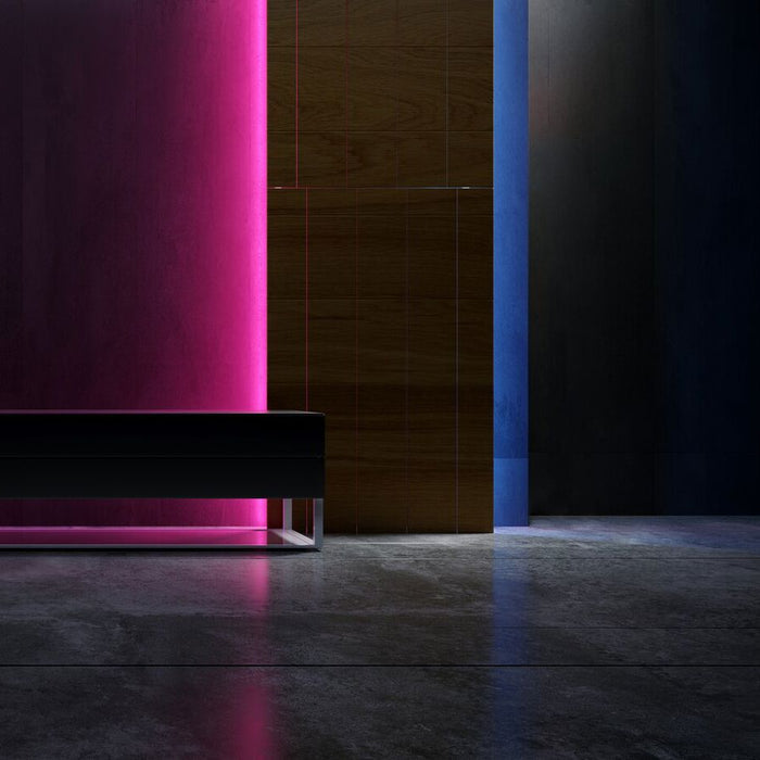 Modern black sofa against a dark wall with rgb neon light