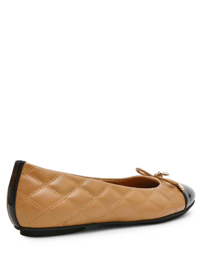 Tan quilted leather ballet flat with black patent cap toe, bow detail, and gold hardware accent