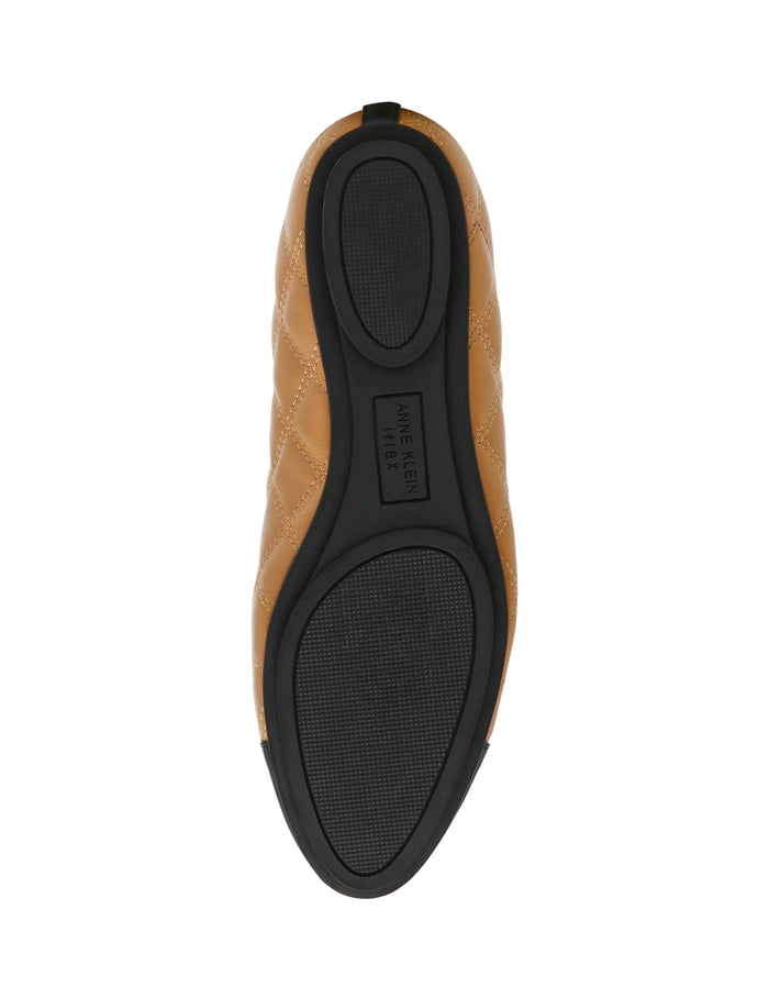 Anne Klein Luci quilted flat bottom view, tan leather upper with diamond stitching and black rubber sole