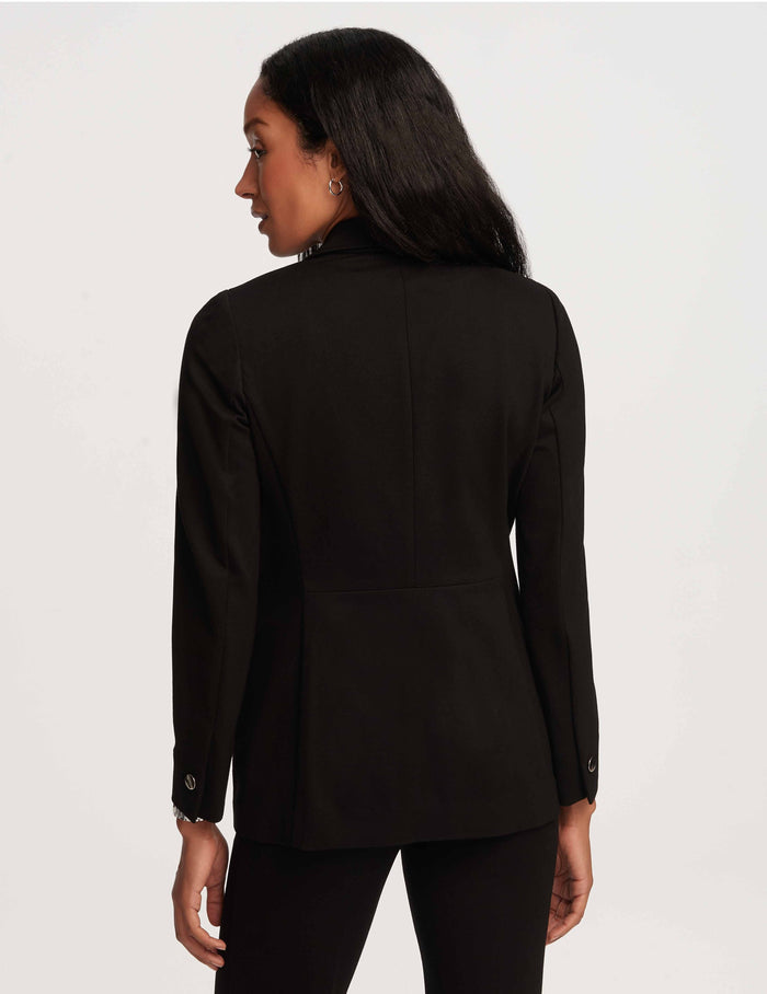 Petite black double breasted blazer jacket with peak lapel, long sleeves, and silver button cuffs, back view