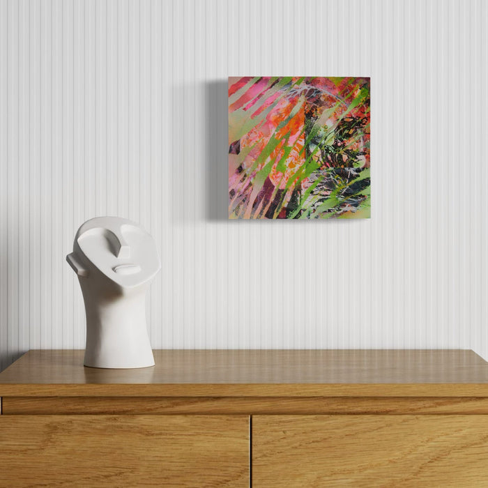 The artwork 'Tiger Waves' by Millie Benson features vibrant abstract expressionism with dynamic brushstrokes in pink, green, and orange hues. Bold diagonal strokes create movement across the wooden panel, while layered gouache and spray paint techniques produce a textured, energetic composition suggesting a wild feline essence in motion. Mixed media artwork on 10x10 wood panel by Millie Benson.